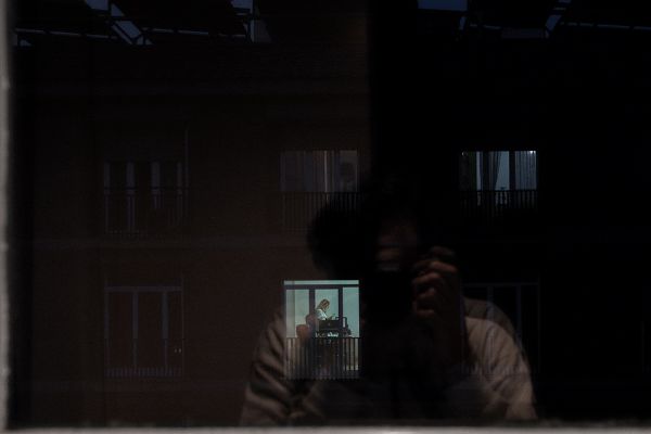 Window overlooking window. Human connection during the lockdown.